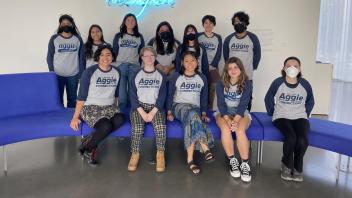 Students sitting and posing for a picture