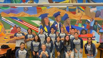 Student from the CASA LLC posing in front of a mural